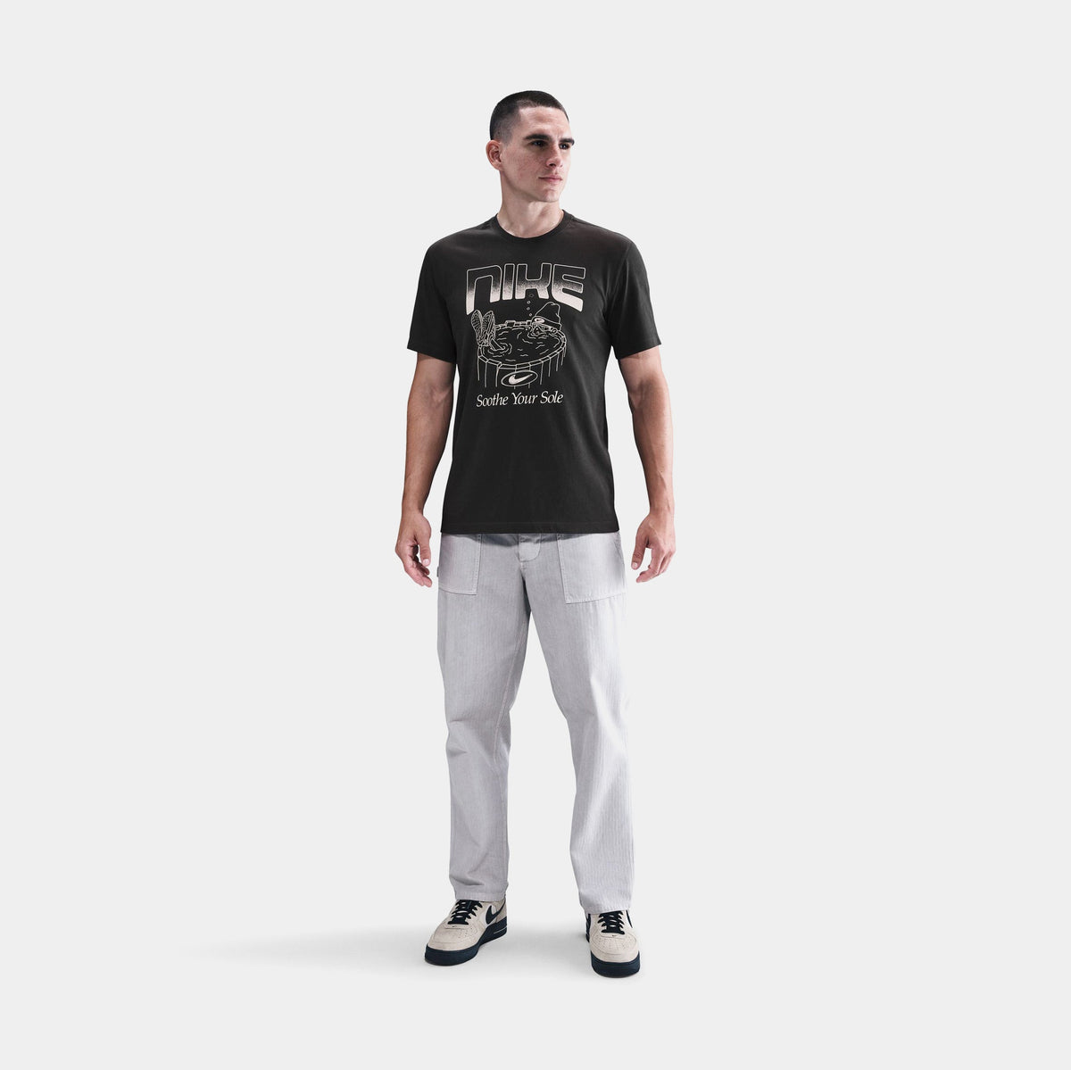 Exclusive NSW Soothe Your Sole Graphic Mens Short Sleeve Shirt (Off Noir) — S — Front View